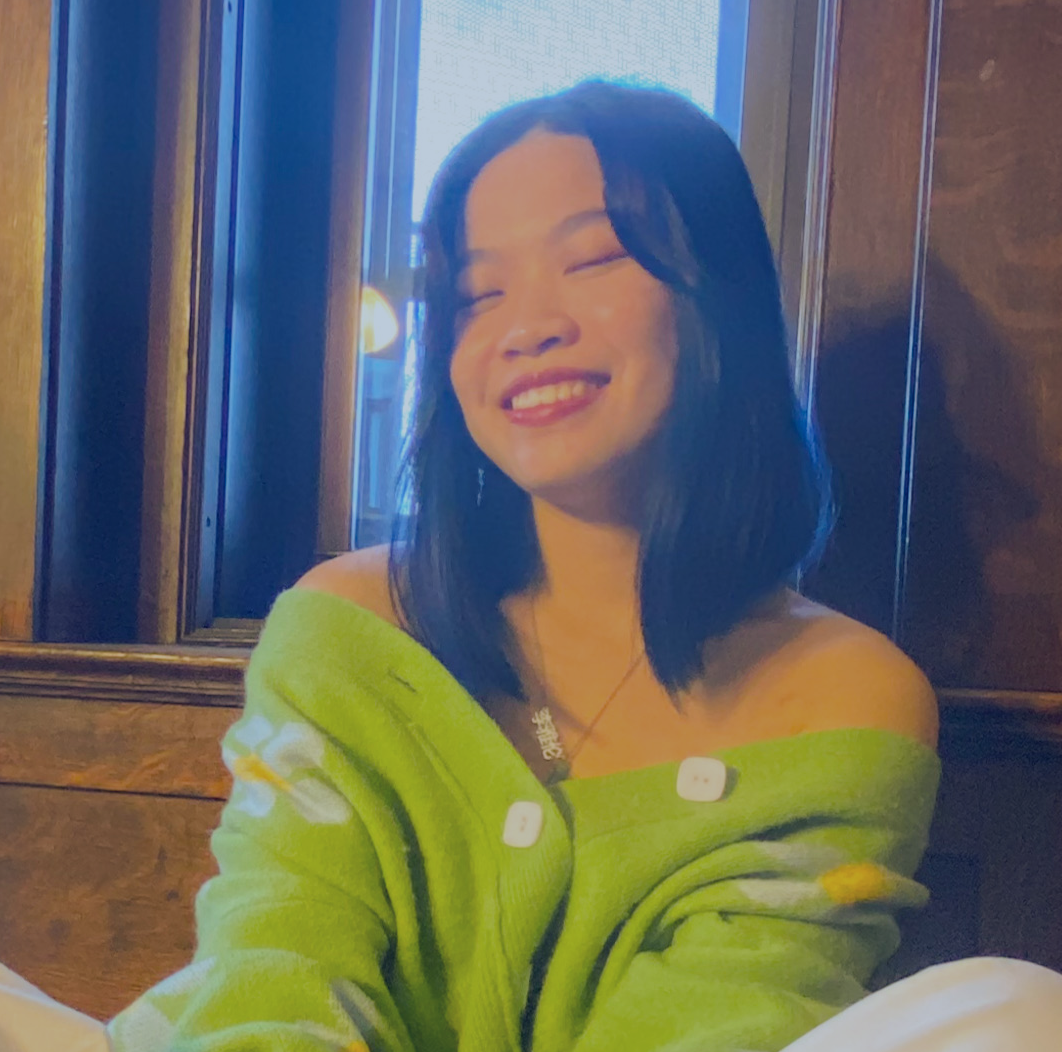 picture of selina wearing green cardigan and smiling
